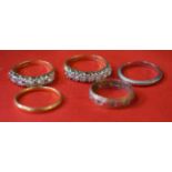 An 18k gold band set with white pastes, together with, a white metal band, a yellow metal band,