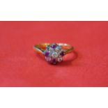 A ruby and diamond cluster ring, to an 18ct gold shank,