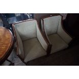 A pair of Edwardian Sheraton revival inlaid wing back chairs.