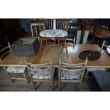 A modern limed oak extending dining suite comprising table,