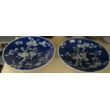 A pair of Chinese blue and white prunus wall chargers each with original retailers label for Frank