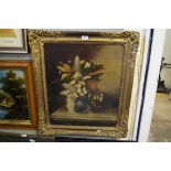 A 19th Century oil on canvas depicting still life flowers in a jug, inset in ornate gilt frame.