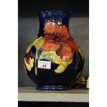 A large Moorcroft Pottery vase of baluster form decorated in the Hibiscus pattern.