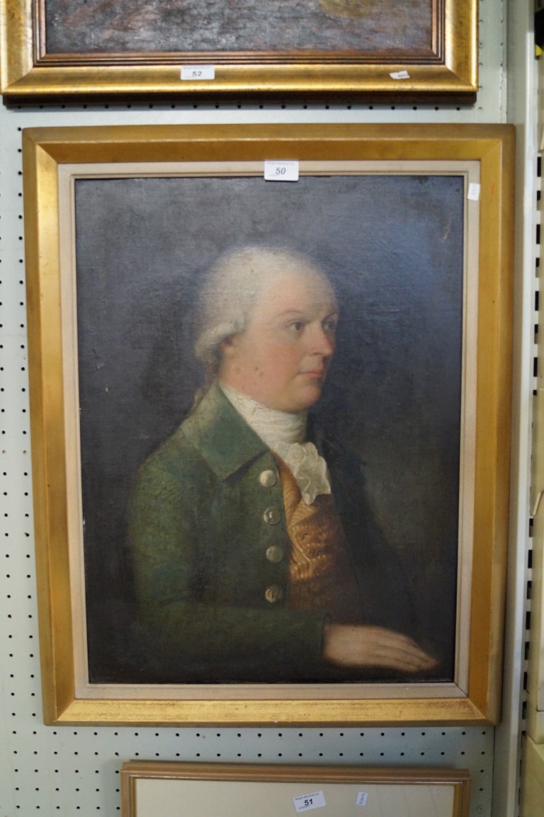 A 19th Century oil on canvas depicting a portrait of a gentleman wearing a green jacket and white