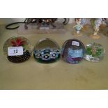 Four assorted glass paperweights to include Caithness example and one possibly Perthshire.