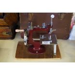 A vintage childrens sewing machine fitted in original carry case.