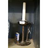 An Arts & Crafts style bronzed candle holder , having side handle with hammered decoration,