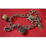 A 9k gold charm bracelet with heart padlock and various charms attached,