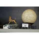 Art Deco desk lamp with gilt metal model of a poodle beside a mottle glass shade.