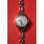 Mappin & Webb: A Ladies 9k gold manual wind bracelet watch, with gold baton markers,