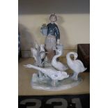 Two pieces of Lladro to include a girl holding a watering can, etc.