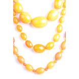 An amber style bead necklace Of butterscotch colour the beads of graduated form,