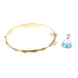A 9ct gold and blue topaz pendant The pear-shaped blue topaz to a plain gold mount, length 2.