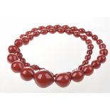 A cherry amber style bead necklace The beads of graduated form, without clasp, length 41cm,
