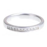 A diamond half hoop eternity ring The uniform line of princess-cut diamonds to a platinum mount,