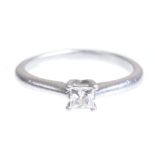A diamond single stone ring The princess-cut diamond, to a four claw setting, platinum mount,