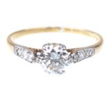 A diamond solitaire ring The round brilliant-cut diamond to graduated diamond shoulders,