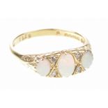 An opal and diamond ring The three graduated oval cabochon opals interspaced by old-cut diamonds,