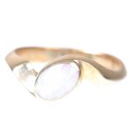 A 9ct gold and opal ring Of oval cabochon-cut opal, set diagonally to a 9ct gold twist mount,