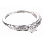 A diamond single stone ring The round brilliant-cut diamond, four claw set,