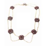 A Victorian Bohemian garnet necklace Composed of graduated rose-cut garnet clusters,