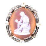 A diamond and pearl shell cameo brooch Of oval form, depicting a Roman man sitting,