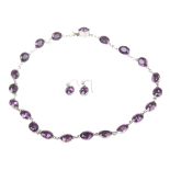 A Victorian amethyst paste rivière necklace and ear pendant suite The line of oval-shaped purple