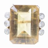 A citrine cocktail ring The emerald-cut citrine, flanked by three colourless collet set pastes,