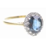 A sapphire and diamond cluster ring The oval-shaped sapphire, to a single-cut diamond surround,