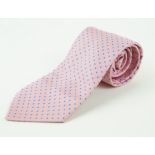 An Hermes silk tie The woven pink ground, with a pale blue repeating polka dot pattern,