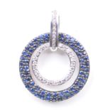 A sapphire and diamond set pendant Of circular form, the outer ring composed of pavé-set sapphires,