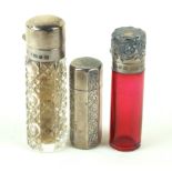 Three Victorian and later perfume bottles To include a hallmarked silver example of octagonal form