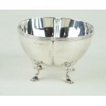 An Edward VII hallmarked silver bowl Having a cast rim, raised on four hoof feet,