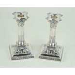 A pair of Edward VII hallmarked silver Corinthian column candlesticks Each having cast decoration