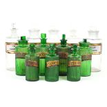 Twelve late 19th/ early 20th Century chemist apothecary bottles Seven green glass examples with