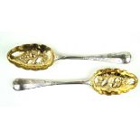 A pair of Victorian hallmarked silver berry spoons Each with gilt bowls and decorated with berries