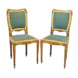 A pair of French carved gilt wood salon chairs Decorated throughout in stylised foliage and swags