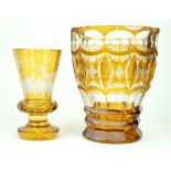 Two Bohemian amber glass vases The larger example having wheel-cut and faceted decoration,