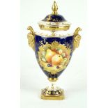 A Coalport twin handled hand-painted pedestal urn vase and cover Decorated with fruit signed KH,