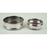 Two hallmarked silver wine coasters The larger example having cast beaded rim, by P H Vogel,