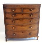 An early 19th Century mahogany bow front chest of drawers Having two short over four long graduated