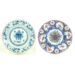 Two 18th Century Delft tin glazed porcelain circular wall chargers The first painted in multi