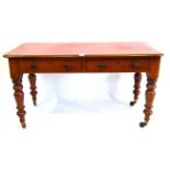 A Victorian mahogany writing table The rectangular top with rounded corners and inset gilt tooled