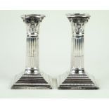 A pair of Victorian hallmarked silver corinthian column candlesticks Each having cast beaded