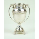A George V hallmarked silver twin handled trophy Having a central cast ribbon,