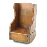 An early 20th Century carved wood apprentice rocking chair The carved wooden sides,