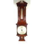 A Victorian mahogany barometer With silvered dial, having carved floral decoration and two columns,