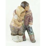 A large Lladro figure group depicting two Eskimos Each wearing traditional clothing,