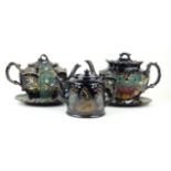 Three 19th Century Jackfield type teapots To include a cylindrical example decorated in gilt with