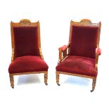 A late Victorian/Edwardian pair of carved walnut framed ladies and gentleman's chairs Each
